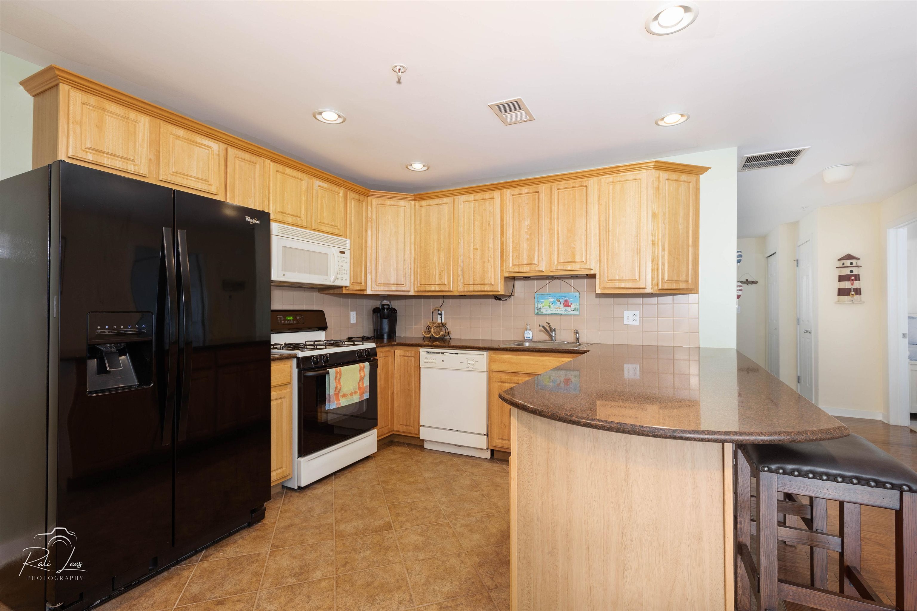 503 East Stanton Road, Unit 403 Wildwood Crest, NJ 08260 - Photo 14 of 42 a kitchen with granite countertop a refrigerator stove top oven and sink