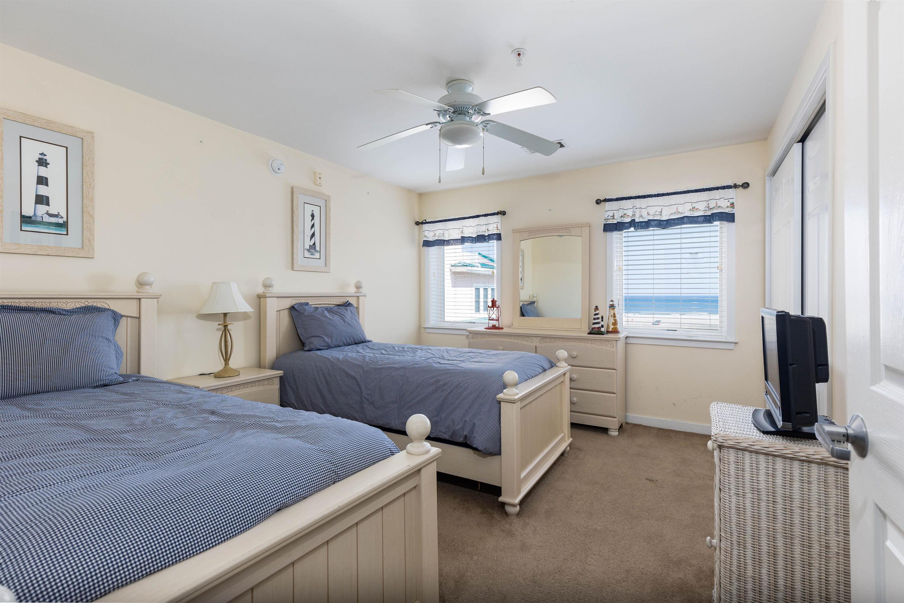 503 East Stanton Road, Unit 403 Wildwood Crest, NJ 08260 - Photo 21 of 42 a bedroom with a bed and a flat screen tv