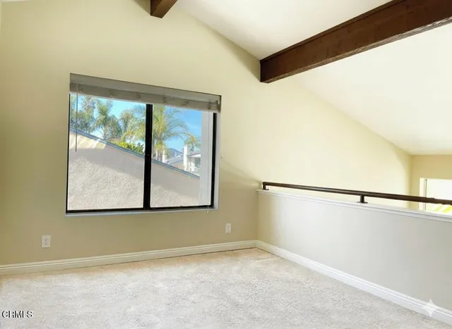 a view of a big room with wooden floor and windows