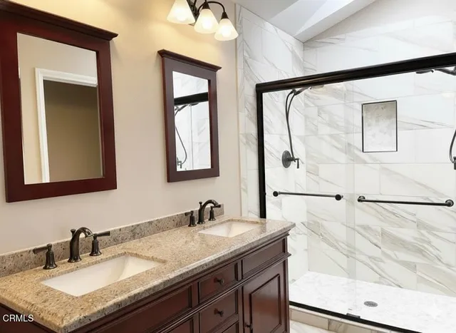 a bathroom with a granite countertop sink mirror and vanity