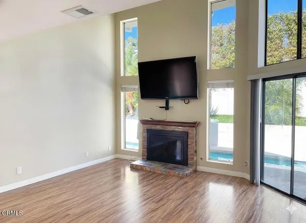 a living room with a fireplace and a flat screen tv
