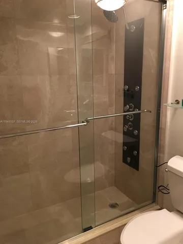 a bathroom with a shower and toilet