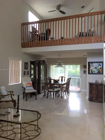 a dining room with furniture window and outdoor view