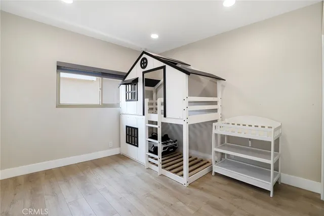 a view of an empty room with wooden walls and stairs