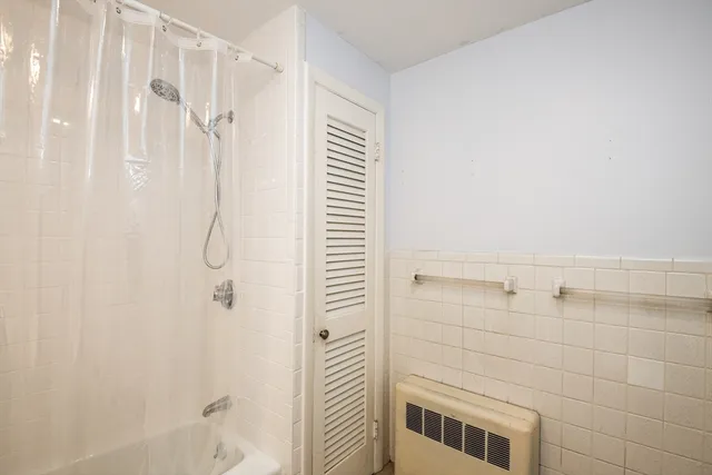 a bathroom with a shower and a shower
