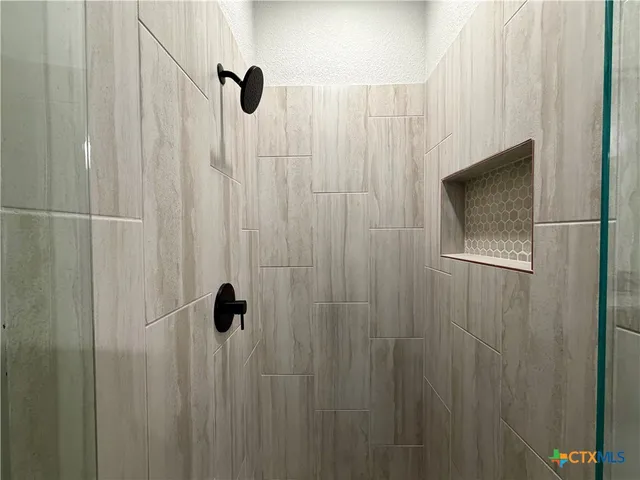 a bathroom with a shower and a shower curtain
