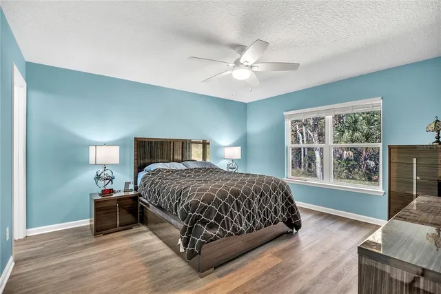 a bedroom with a large bed and a window