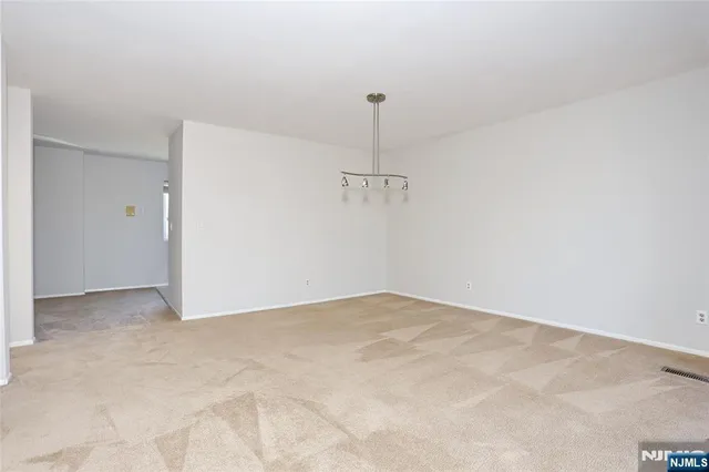 a view of an empty room with a fan