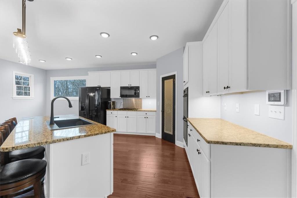 5488 Price Road Gainesville, GA 30506 - Photo 16 of 55 a kitchen with stainless steel appliances granite countertop refrigerator sink and stove