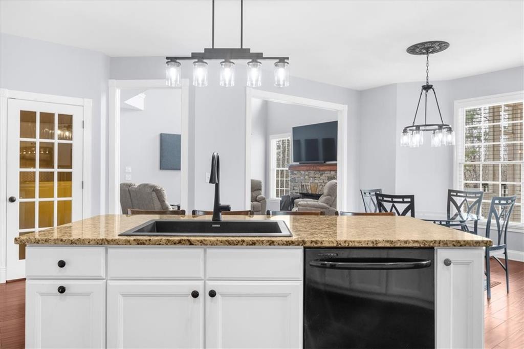 5488 Price Road Gainesville, GA 30506 - Photo 18 of 55 a kitchen with granite countertop a sink stainless steel appliances and cabinets