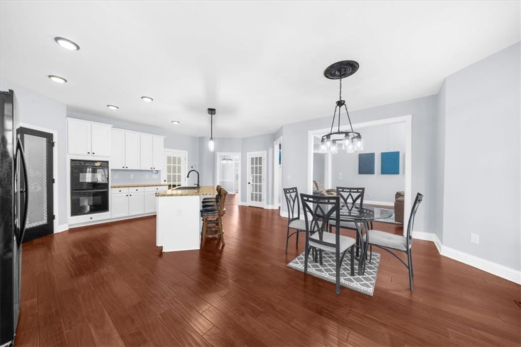 5488 Price Road Gainesville, GA 30506 - Photo 20 of 55 a view of a dining room with furniture and wooden floor