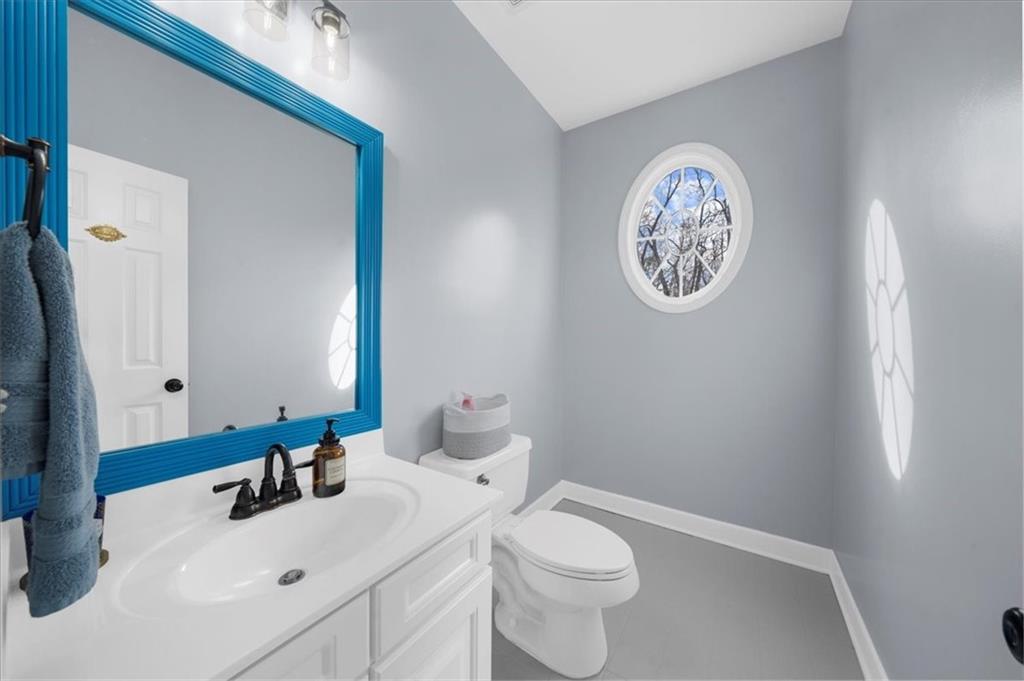 5488 Price Road Gainesville, GA 30506 - Photo 26 of 55 a bathroom with a toilet sink and mirror