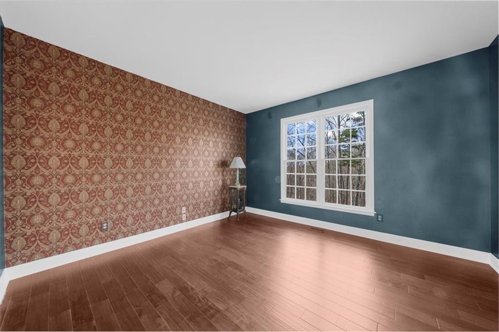 5488 Price Road Gainesville, GA 30506 - Photo 27 of 55 a view of an empty room with wooden floor and a window