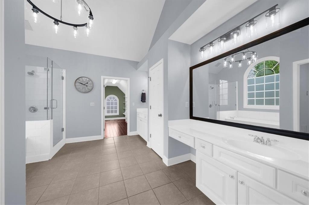 5488 Price Road Gainesville, GA 30506 - Photo 31 of 55 a bathroom with a sink a mirror and a bathtub