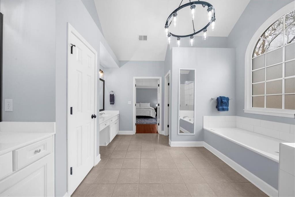 5488 Price Road Gainesville, GA 30506 - Photo 37 of 55 a spacious en suite bathroom with a tub shower and a sink
