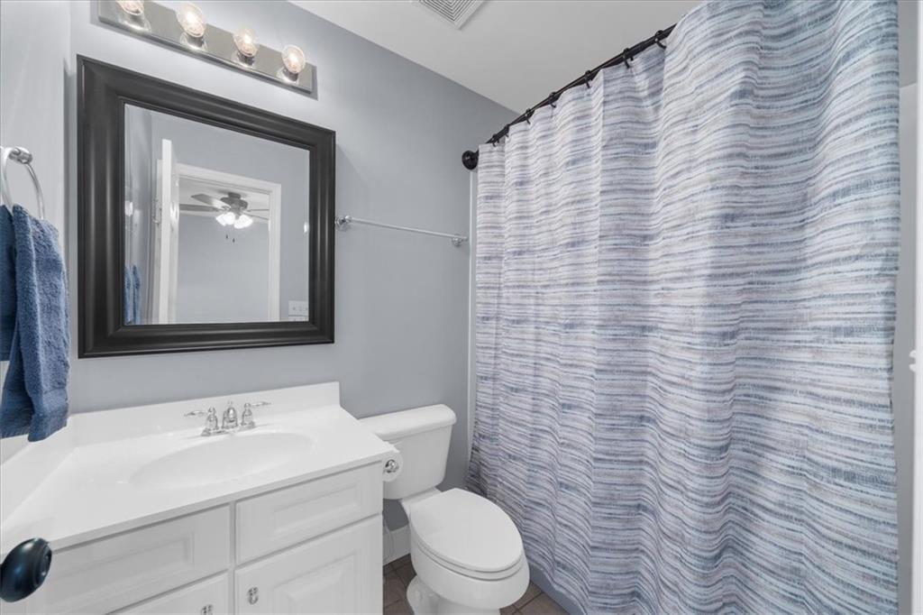 5488 Price Road Gainesville, GA 30506 - Photo 39 of 55 a bathroom with a toilet a sink and mirror