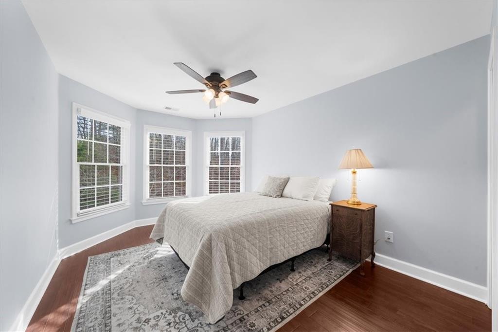 5488 Price Road Gainesville, GA 30506 - Photo 41 of 55 a bedroom with a large bed chandelier and a window