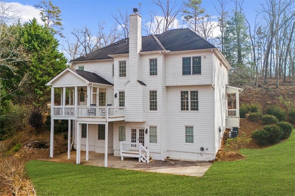 5488 Price Road Gainesville, GA 30506 - Photo 5 of 55 a view of a yard in front of a house with plants and large tree