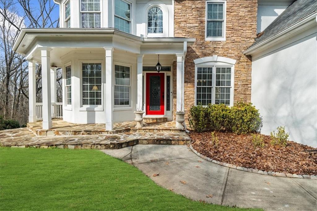 5488 Price Road Gainesville, GA 30506 - Photo 6 of 55 a view of a brick house with a yard and large tree