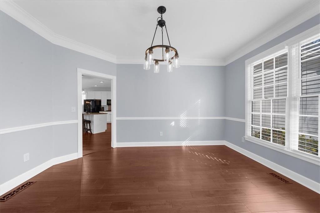 5488 Price Road Gainesville, GA 30506 - Photo 8 of 55 a view of empty room with wooden floor fan and window