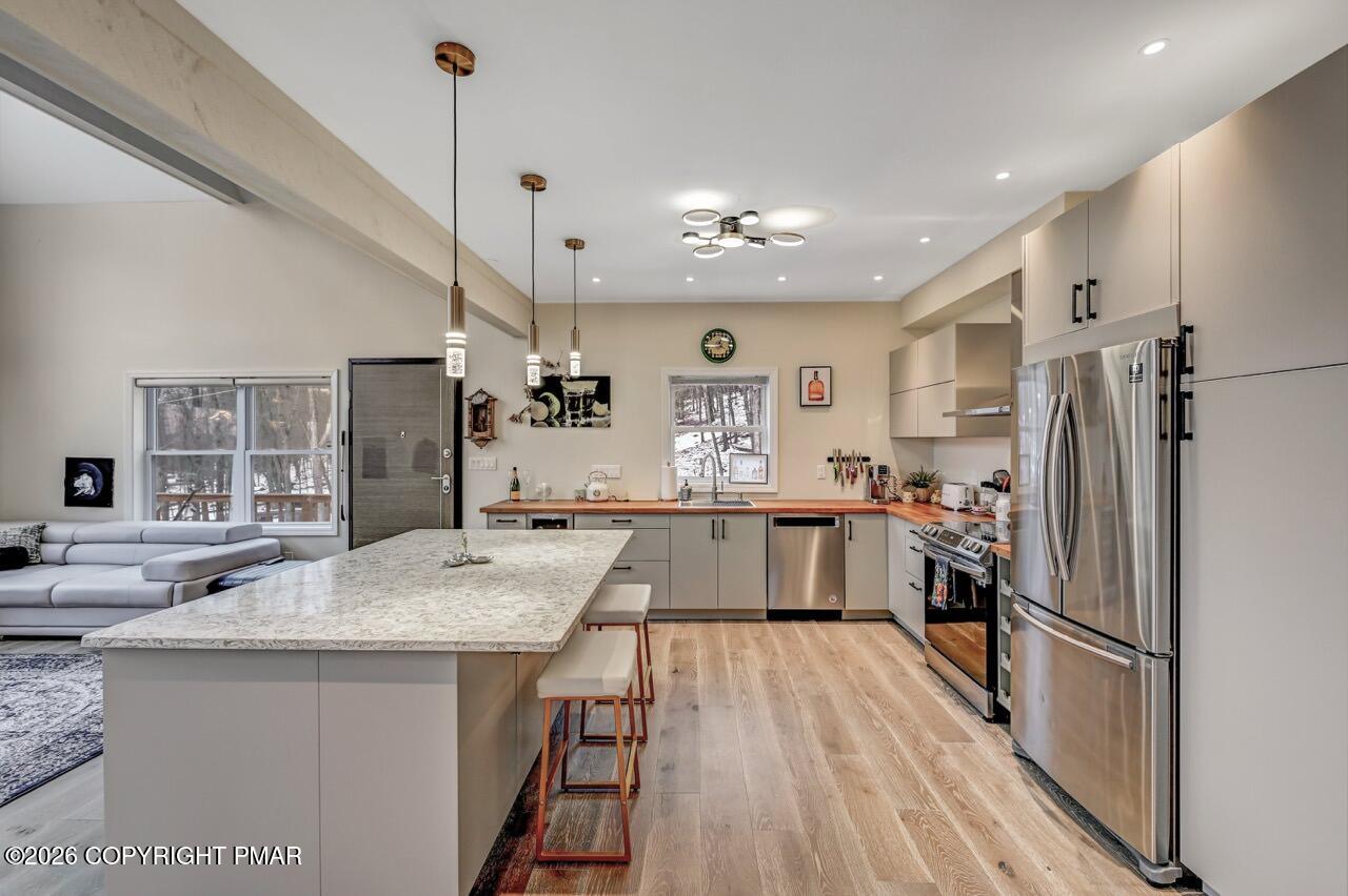 325 Chestnut Road East Stroudsburg, PA 18302 - Photo 18 of 50 a kitchen with refrigerator a sink and wooden floor