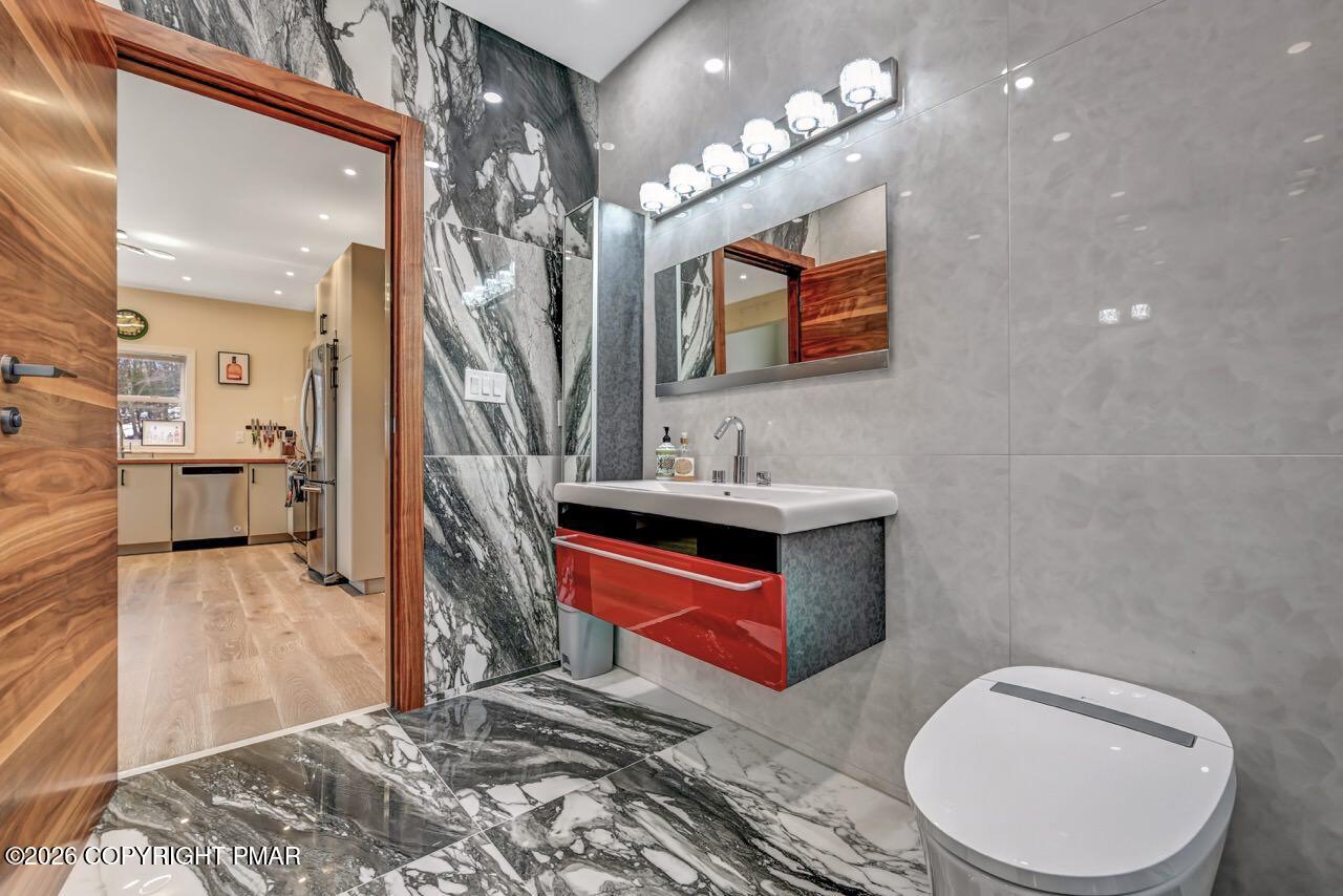 325 Chestnut Road East Stroudsburg, PA 18302 - Photo 25 of 50 a bathroom with a toilet sink and mirror