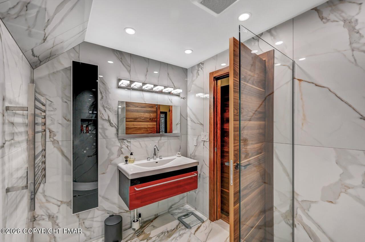 325 Chestnut Road East Stroudsburg, PA 18302 - Photo 39 of 50 a bathroom with a double vanity sink a mirror and shower