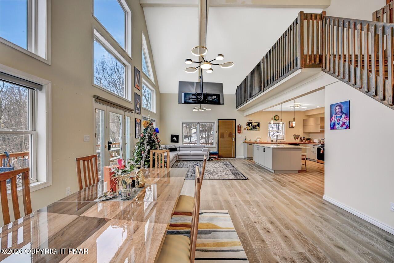 325 Chestnut Road East Stroudsburg, PA 18302 - Photo 10 of 50 a view of a living room and kitchen with furniture wooden floor and windows