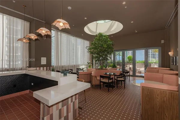 an outdoor dining space with furniture and chandelier