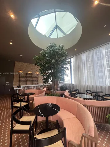 a outdoor space with lots of chairs and a chandelier