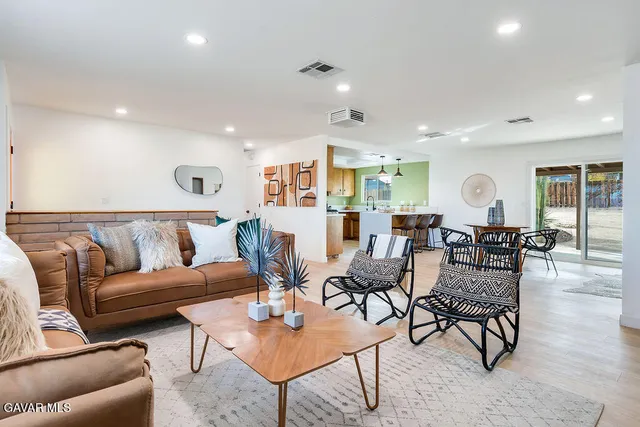 a living room with lots of furniture and a wooden floor