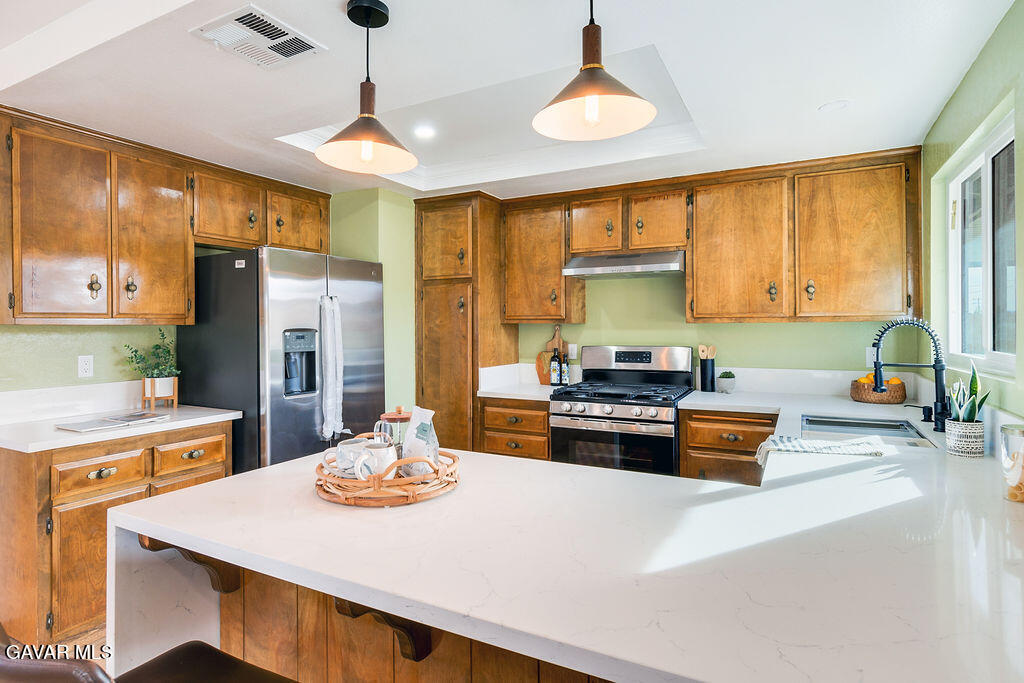 73843 White Sands Drive Twentynine Palms, CA 92277 - Photo 16 of 32 a kitchen with a refrigerator a stove a sink dishwasher with a dining table and chairs