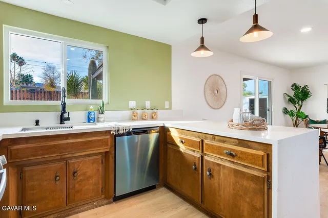 a kitchen with a sink and a clock on the wall