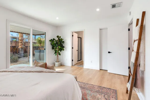 a bedroom with a large bed and a large window