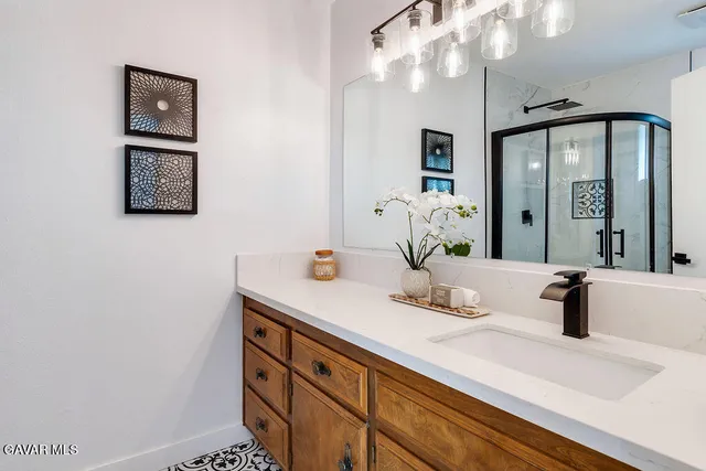a bathroom with a sink a large mirror and a vanity