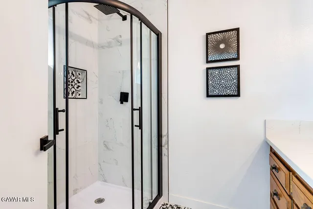 a bathroom with a shower and a mirror