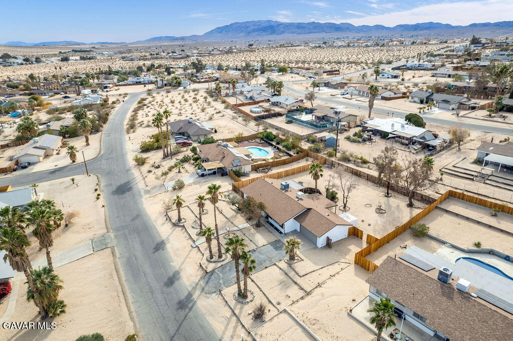 73843 White Sands Drive Twentynine Palms, CA 92277 - Photo 7 of 32 an aerial view of residential building with parking and trees