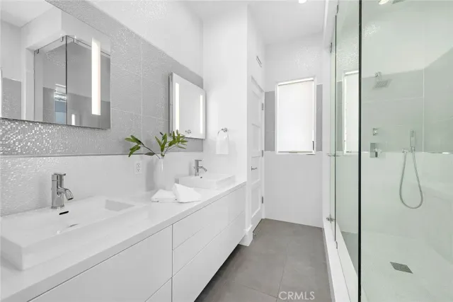 a bathroom with a double vanity sink and mirror