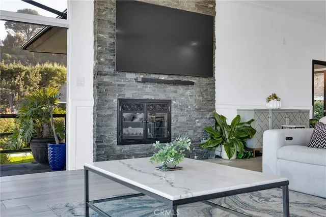 a dining room with fireplace and wooden floor