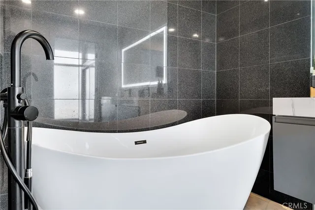 a white bath tub sitting in a bathroom