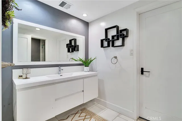 a bathroom with a double vanity sink mirror and vanity