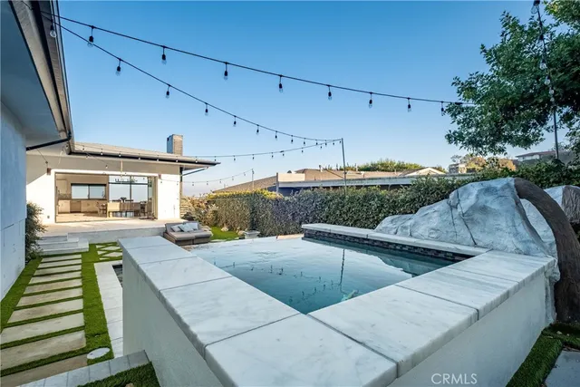 a view of a patio with table and chairs with wooden floor and fence