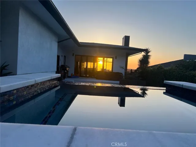 a kitchen with a sink and dishwasher a stove top oven with wooden floor