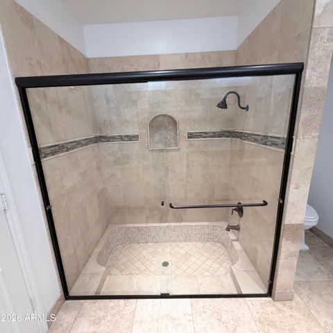 a bathroom with a toilet and a shower