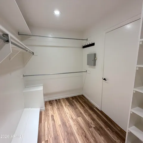 a spacious bathroom with a granite countertop sink and a mirror