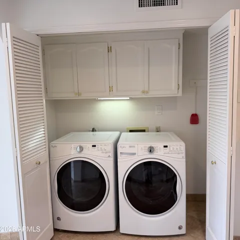 a view of a house with backyard porch and sitting area