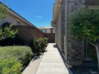 a view of a pathway both side of house