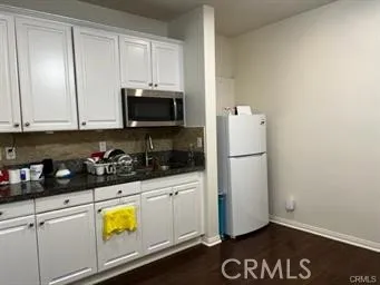 a kitchen with a refrigerator and a stove