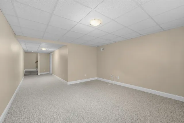 an empty room with a empty space and windows