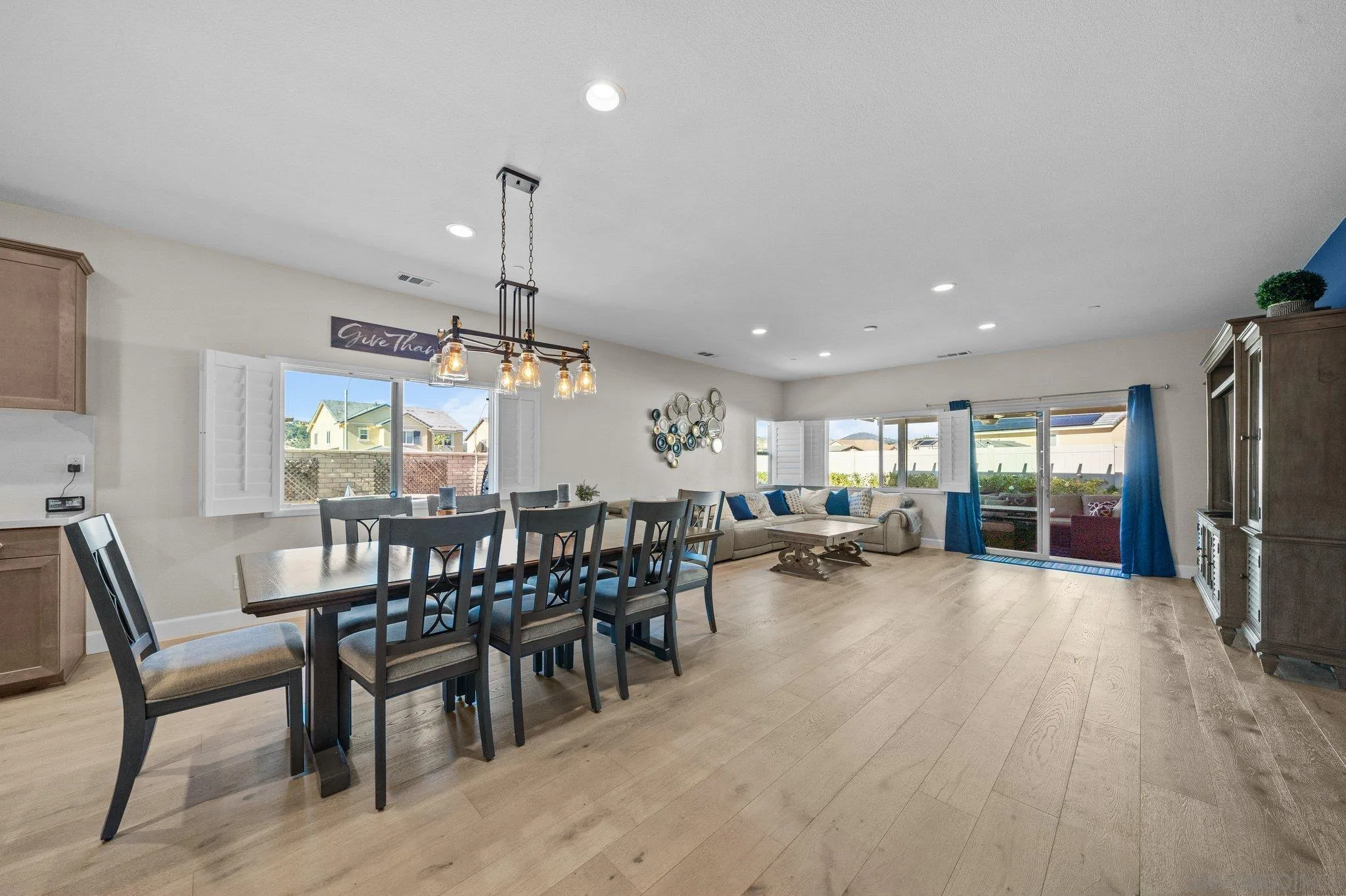35778 Esperia Way Fallbrook, CA 92028 - Photo 24 of 44 a view of a dining room and livingroom with furniture wooden floor a chandelier